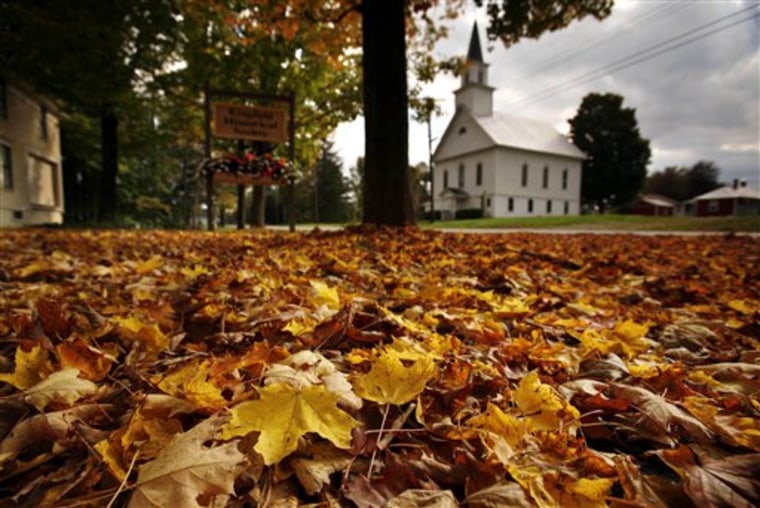 Fallen maple leaves carpet a lawn across the street from the First Baptist Church of Kingfield, Maine, on Sept. 30.